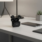BGT Classic wireless earbuds open case on desk next to smartphone - lifestyle shot