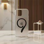 iPhone 14 Pro Max clear magnetic case on phone showing magnetic ring - marble and wood background