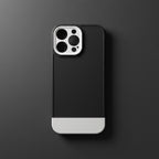 iPhone 14 Pro Max black and white case flat lay on dark grey background - top view