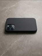 iPhone 12 Pro sky blue silicone case flat lay on dark background - top view