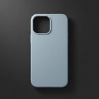 iPhone 12 Pro black silicone case lying flat on marble surface - lifestyle shot