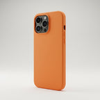 iPhone 16 Pro Max orange silicone case on phone angled on white background - lifestyle shot